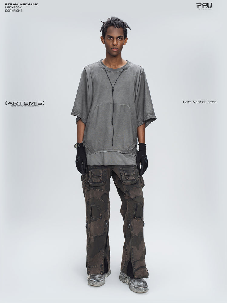 IXION dead leaf brown washed camouflage combat pants — full-length front modeled view styled with a gray tee