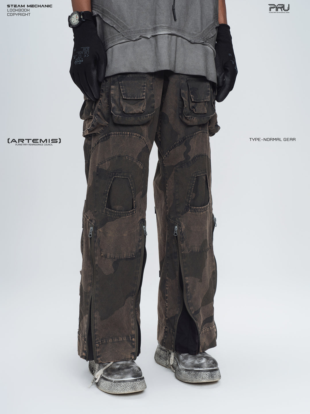 IXION dead leaf brown washed camouflage combat pants — three-quarter front lower-body modeled view with outer-leg zippers