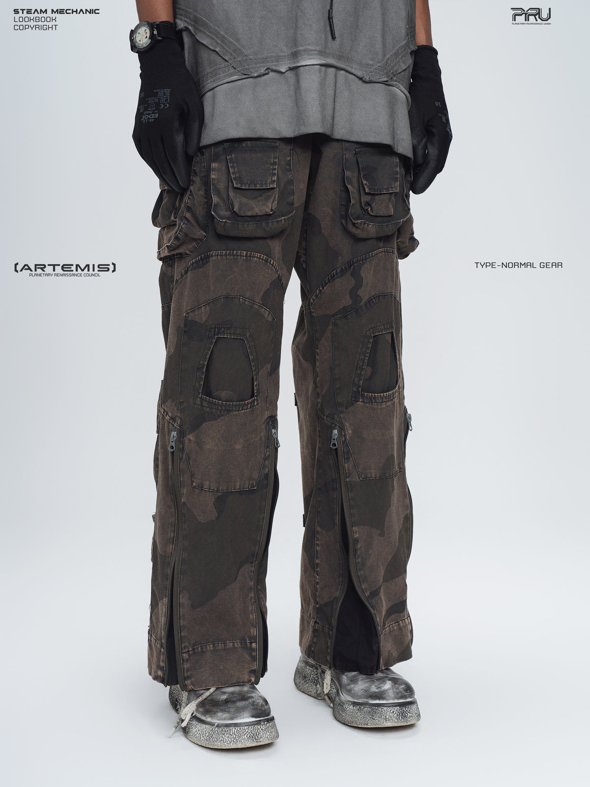 IXION dead leaf brown washed camouflage combat pants — three-quarter front lower-body modeled view with outer-leg zippers