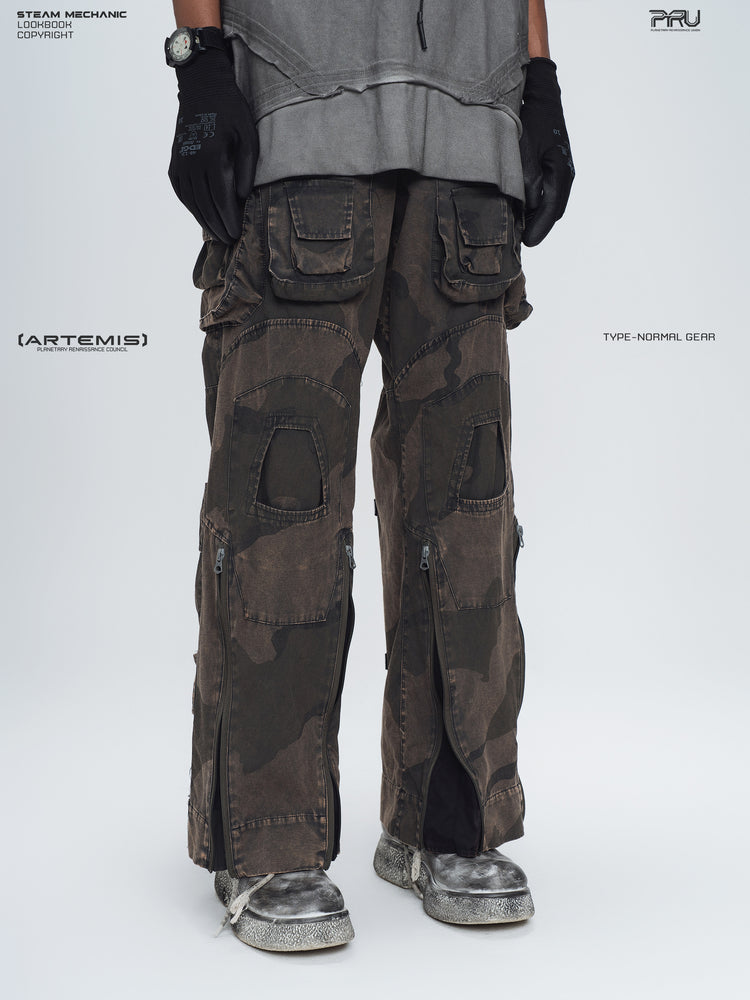 IXION dead leaf brown washed camouflage combat pants — three-quarter front lower-body modeled view with outer-leg zippers