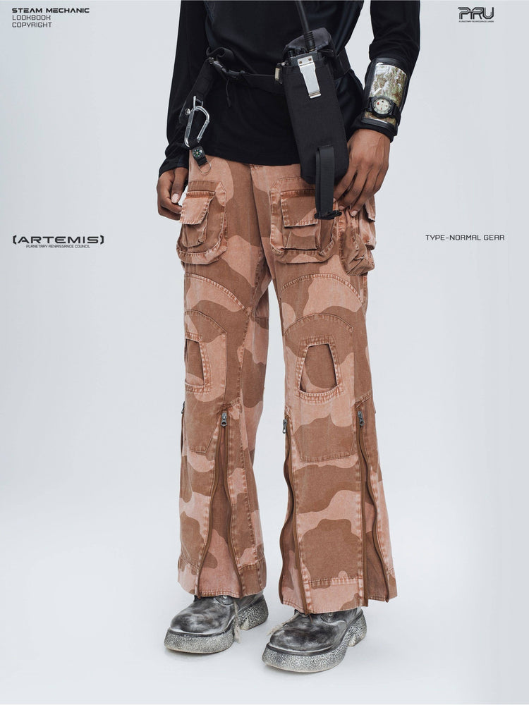 IXION washed camouflage combat pants in dune red — close modeled front view showing layered cargo pockets and leg zippers