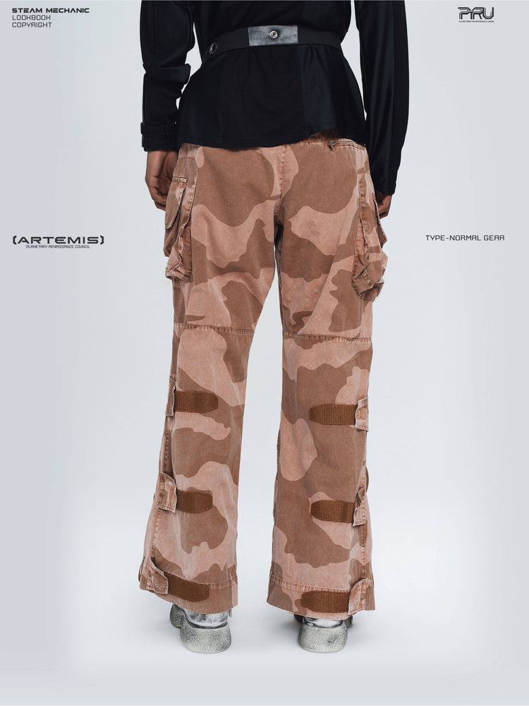 IXION washed camouflage combat pants in dune red — close modeled back view showing camouflage panels and leg straps