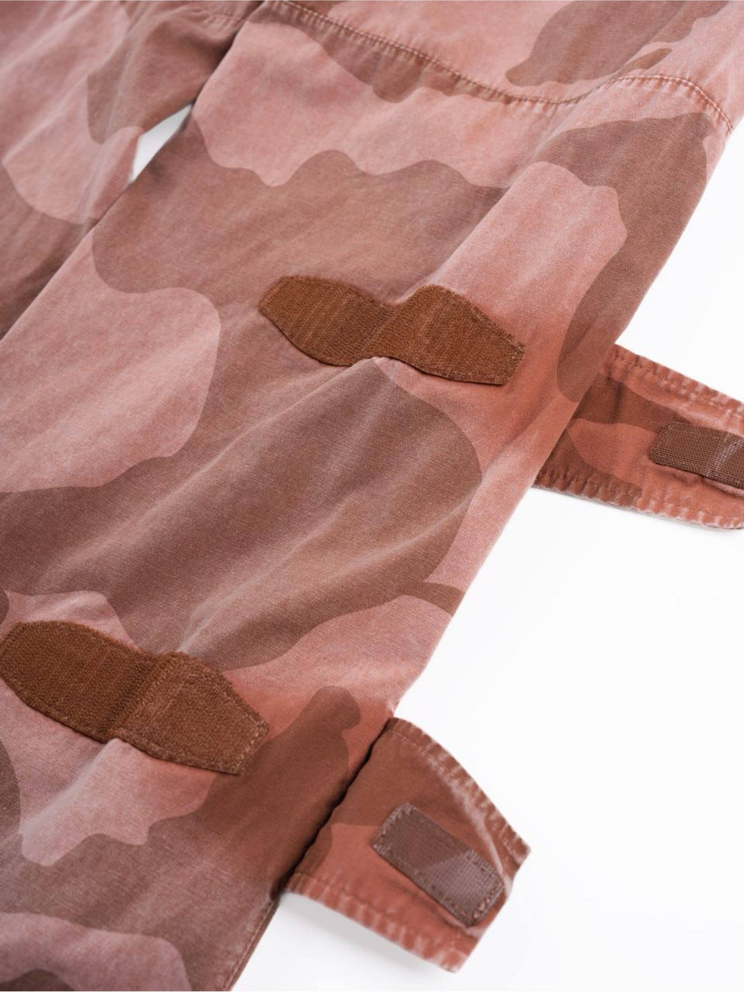 IXION washed camouflage combat pants in dune red — close-up of adjustable lower-leg hook-and-loop straps