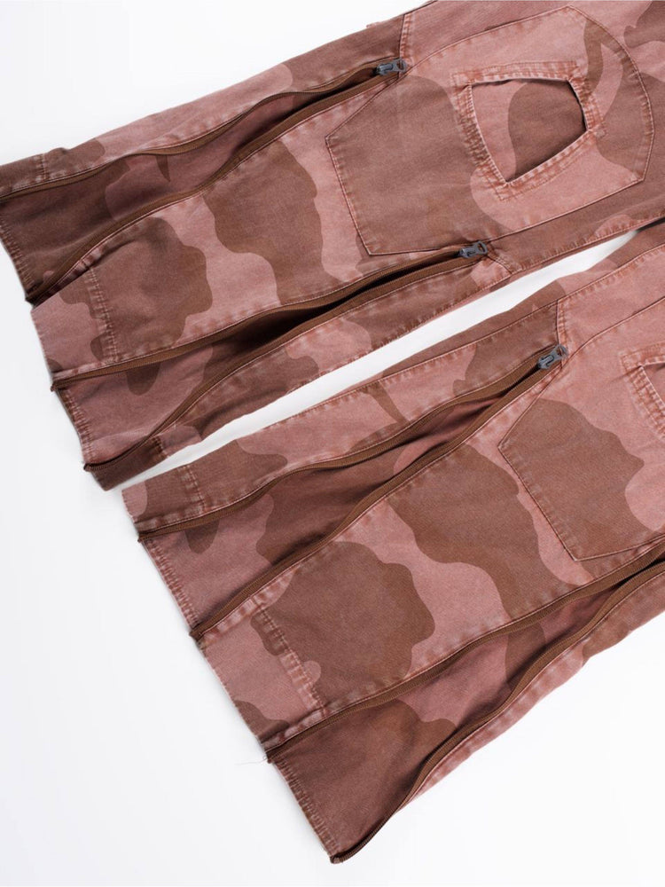 IXION washed camouflage combat pants in dune red — close-up of lower-leg zip openings and knee panels