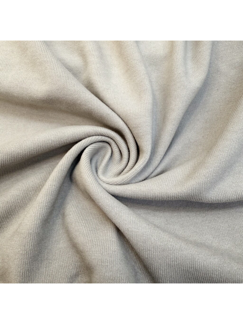ERODED SPINE distressed asymmetric tee — close-up of the washed cotton fabric texture
