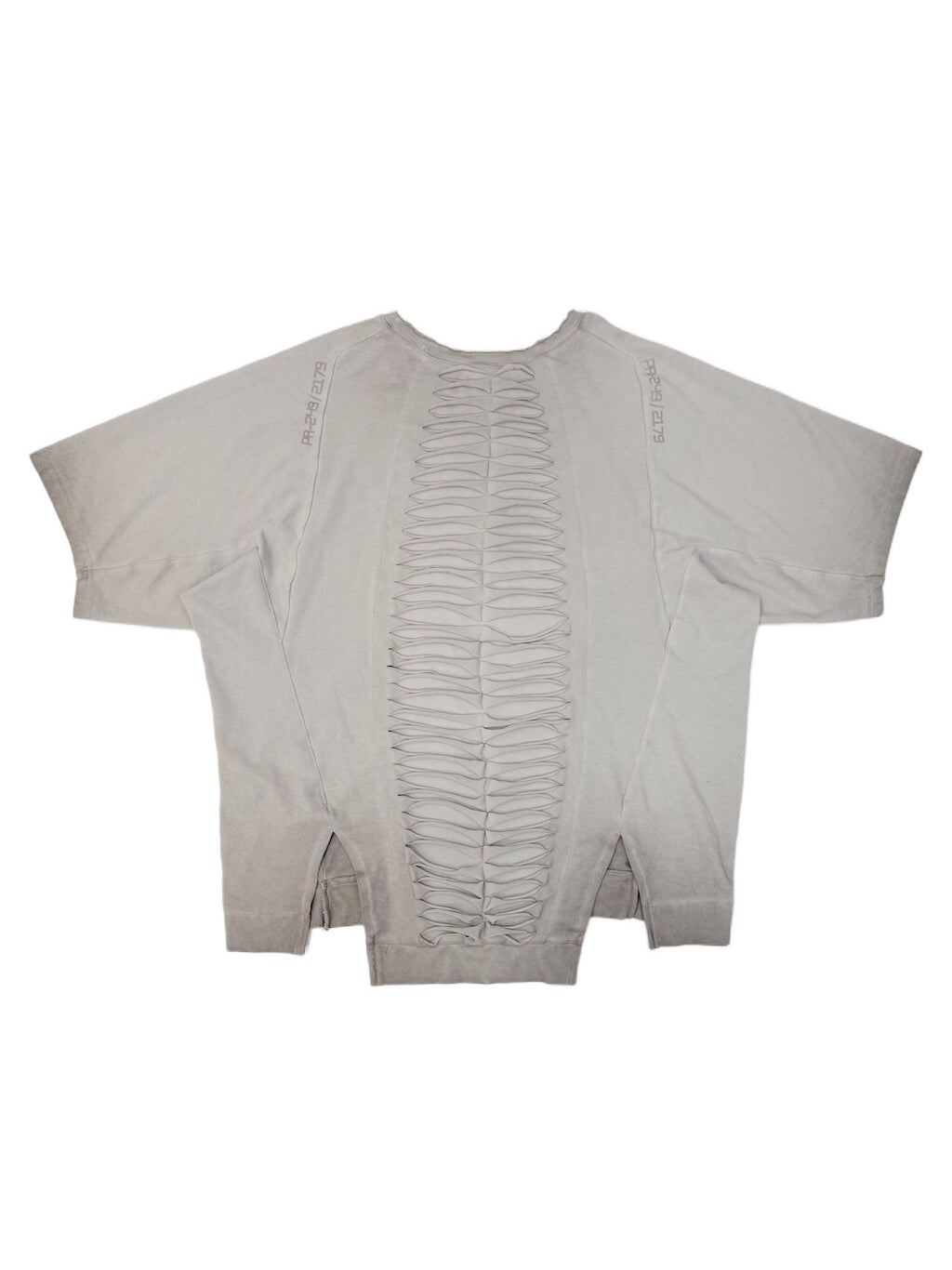 ERODED SPINE distressed asymmetric tee — oxidized white back flat lay showing the spine-like cutouts
