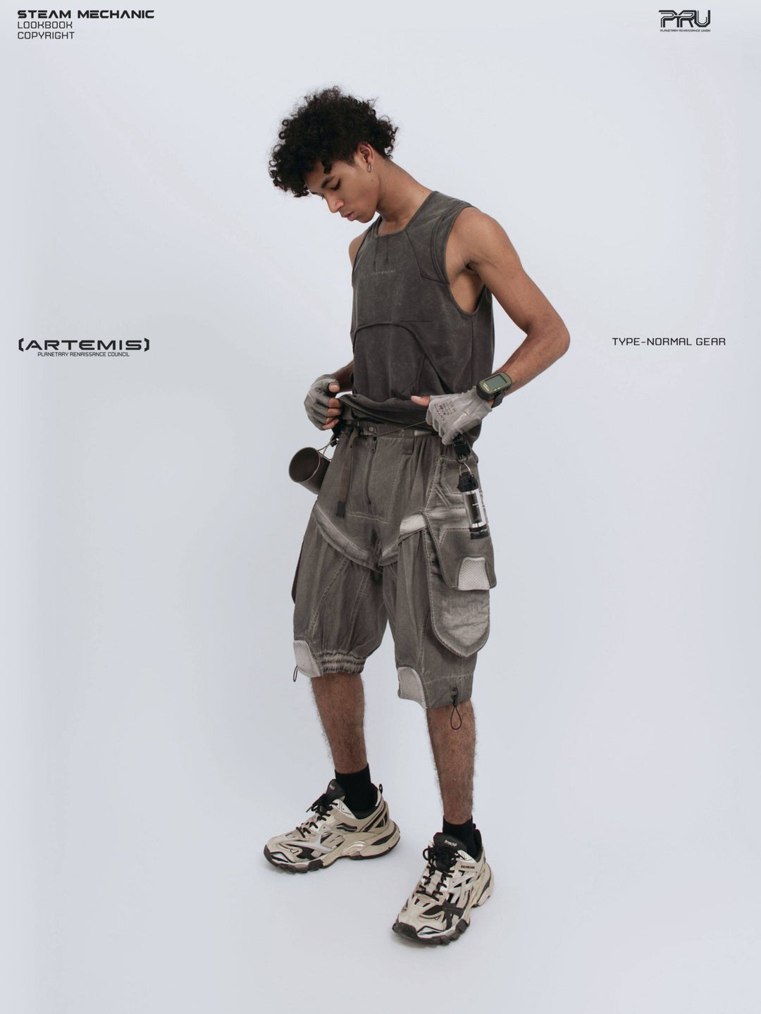 RIFT ARC deconstructed tank in washed gray — side-front modeled view lifting the hem