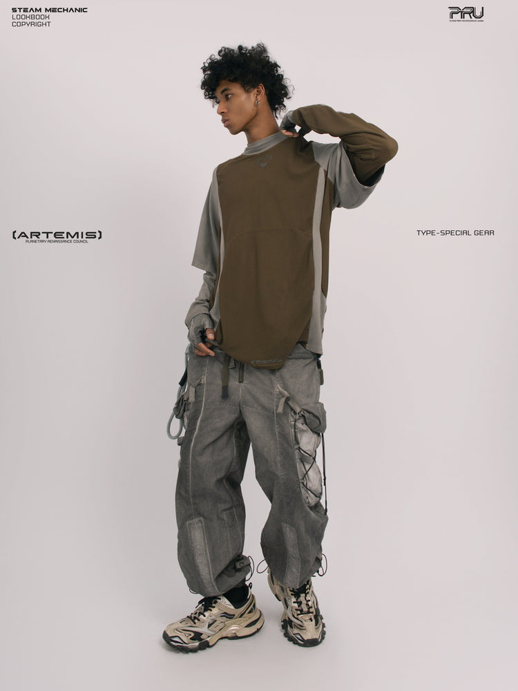 STARFIELD WELDER steel tundra distressed mesh tee — full-length front view with one arm raised, styled with a long-sleeve layer