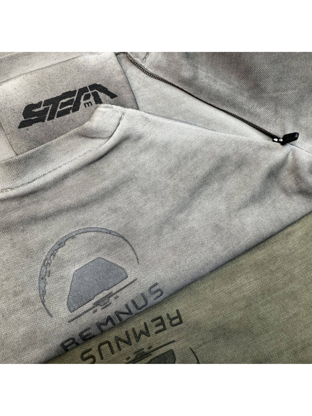 TWIN STAR lunar soil teal stretch riding base-layer top — folded garment detail showing collar construction and chest marks in both colorways