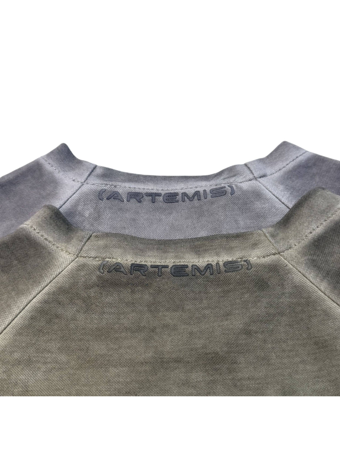 TWIN STAR meteor gray stretch riding base-layer top — close-up of both colorways showing the ARTEMIS back-neck marks