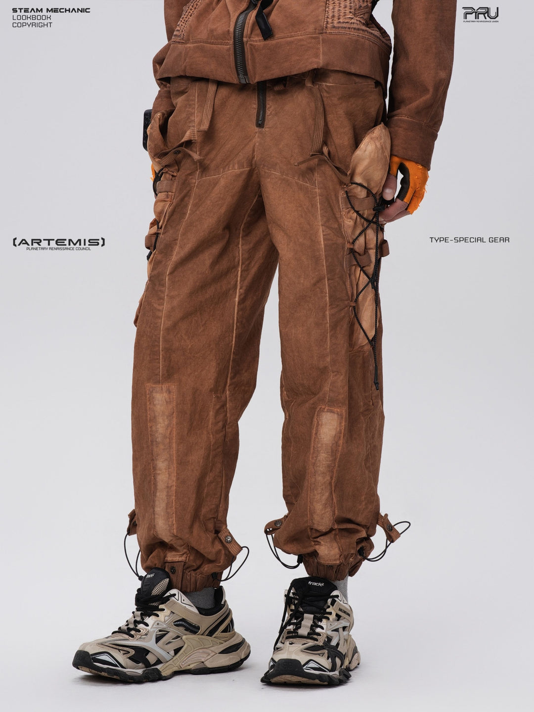 PIONEER detachable waist-pouch cargo pants in corona orange — angled front close-up of the utility pockets