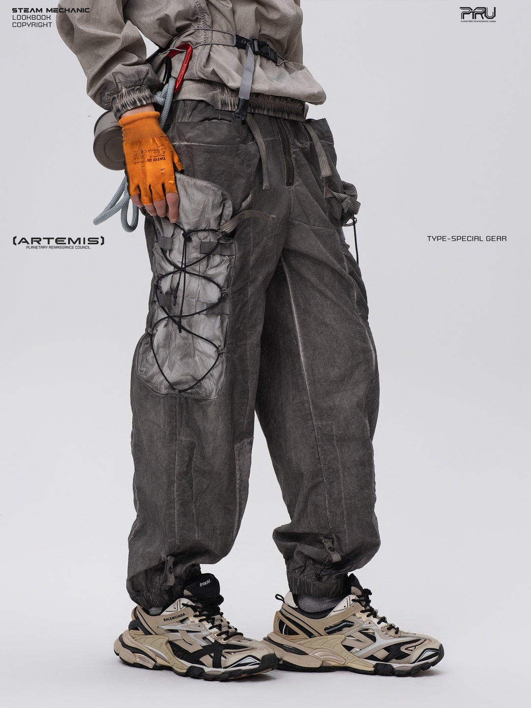 PIONEER detachable waist-pouch cargo pants in meteorite gray — three-quarter close-up showing the zip fly and pocket opening