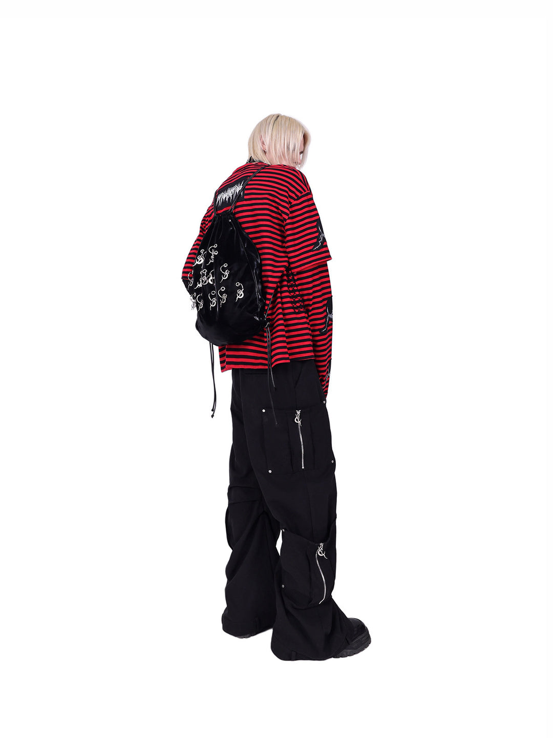 PINKSPINK ELECTRIC MOON striped patchwork long-sleeve tee — red and black three-quarter back view styled with a black backpack