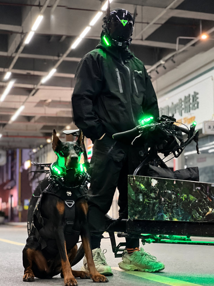 FOCKSHOP ANUBIS black illuminated horned cyber mask — full-length modeled view beside a bicycle and dog