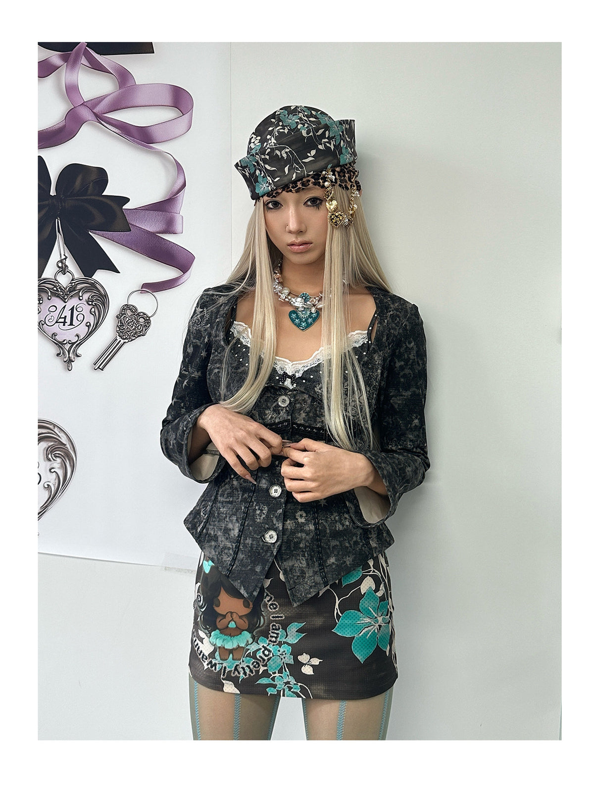 4RE1GN MYSTIC floral fitted jacket in black gray — front modeled view beside the bow display with hands at the buttons