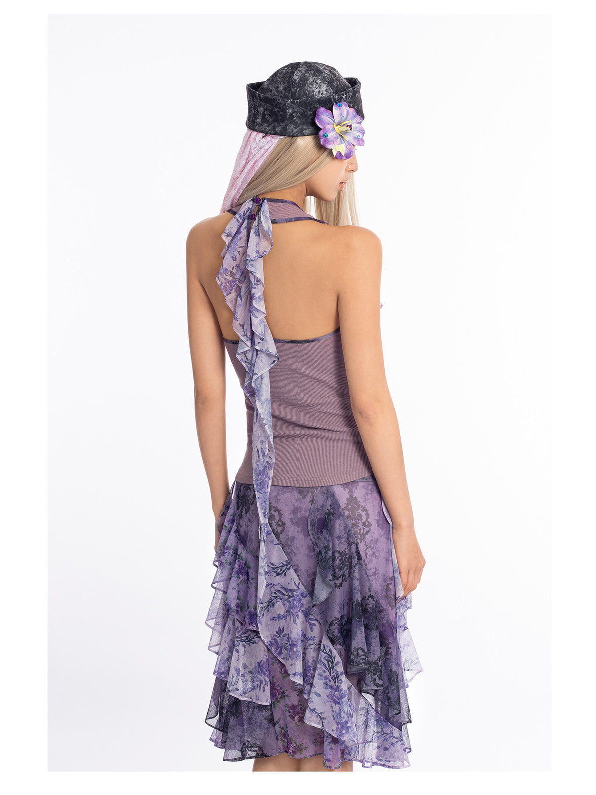 4RE1GN PURPLE HAZE asymmetric ruffle skirt in purple — rear three-quarter modeled view showing the layered ruffles