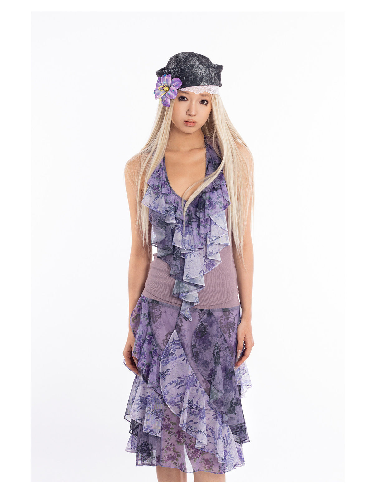 4RE1GN PURPLE HAZE asymmetric ruffle skirt in purple — close front modeled view styled with a purple halter top