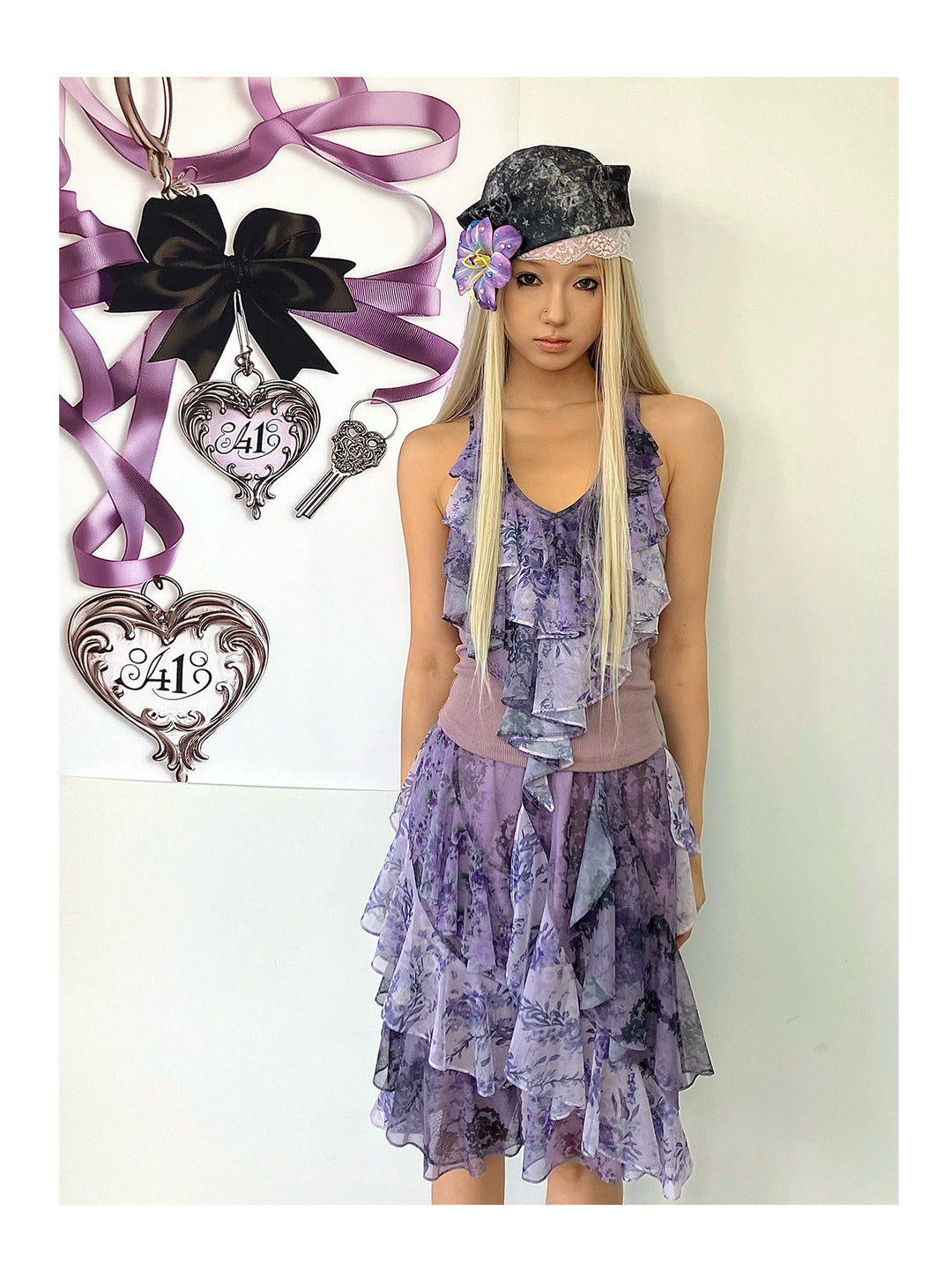 4RE1GN PURPLE HAZE asymmetric ruffle skirt in purple — front modeled view beside the bow display