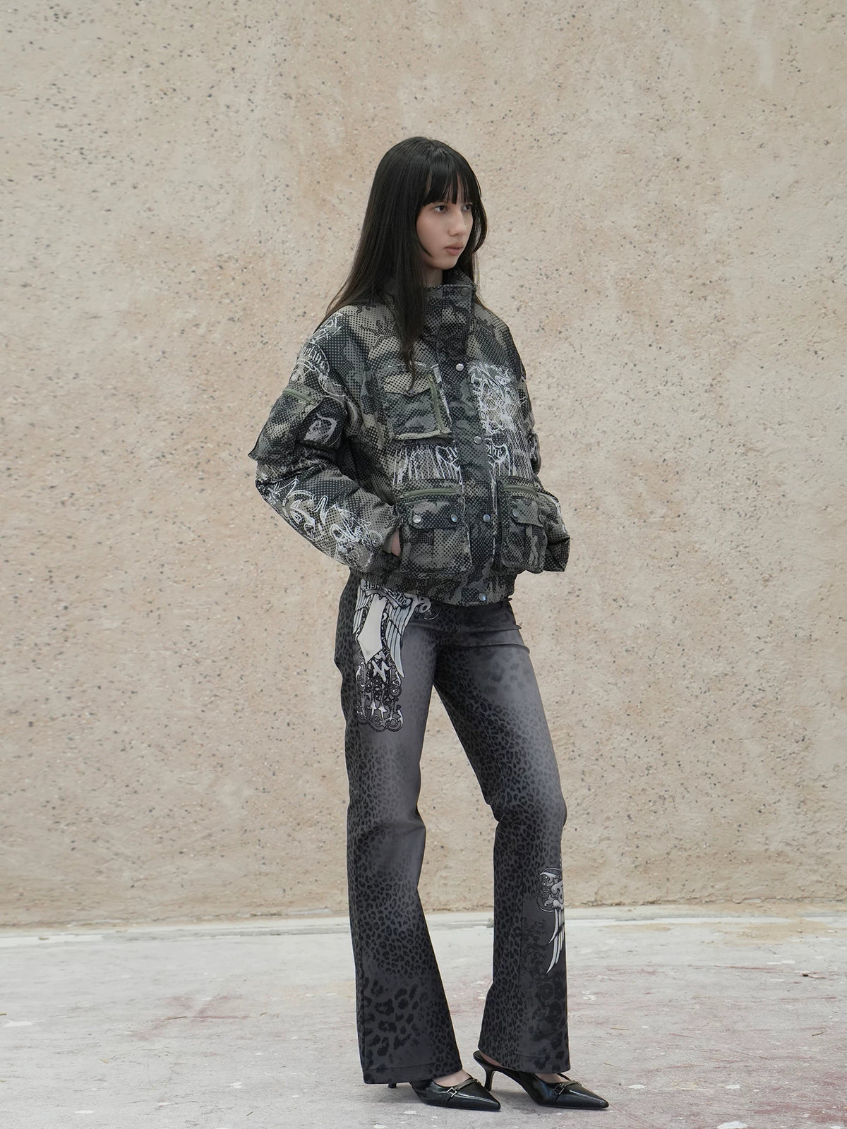 4RE1GN PANTHER crest-print corduroy flare pants in gray black — full-length side modeled view showing the flared leg