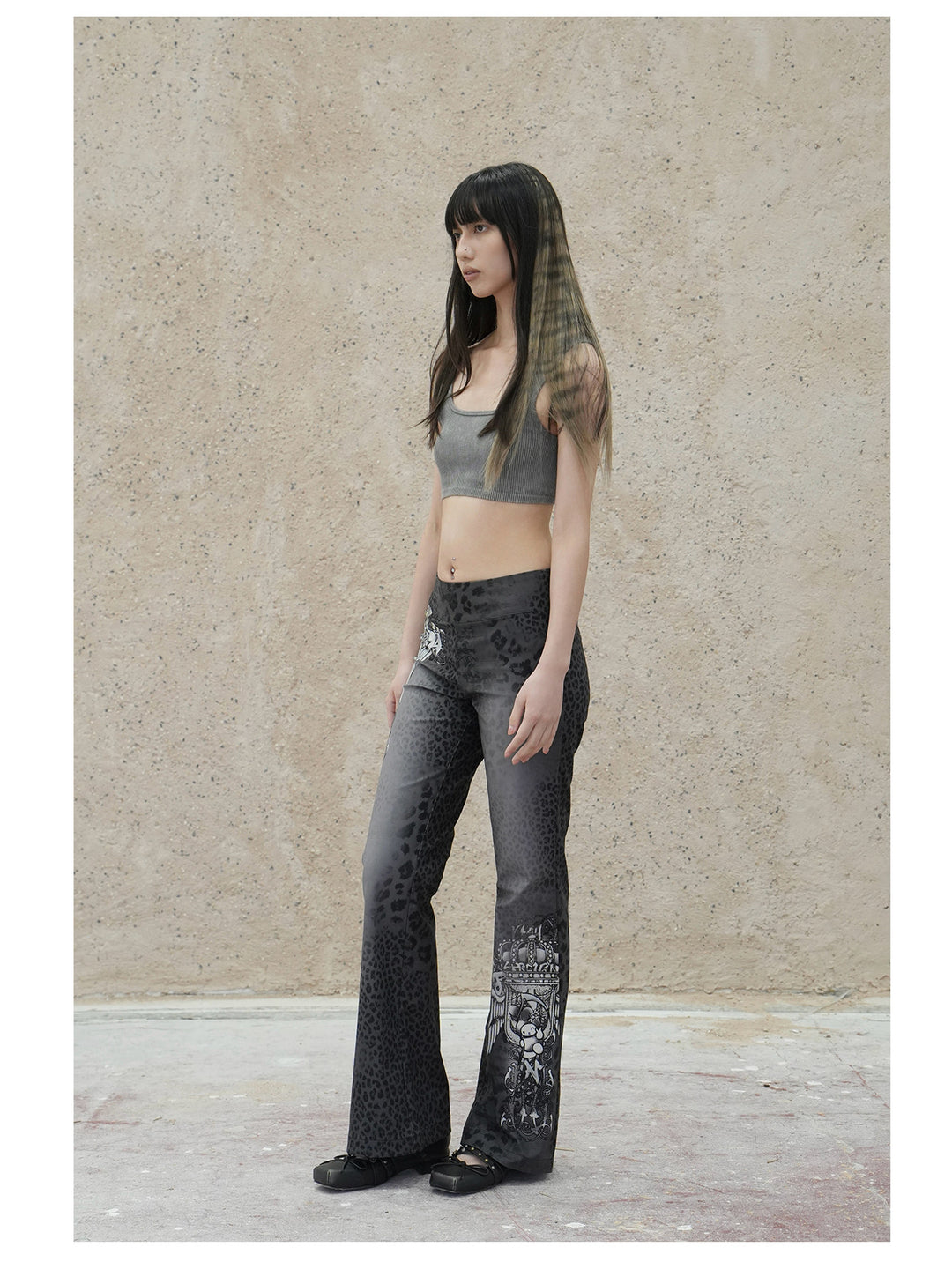4RE1GN PANTHER crest-print corduroy flare pants in gray black — full-length front modeled view styled with a gray crop top