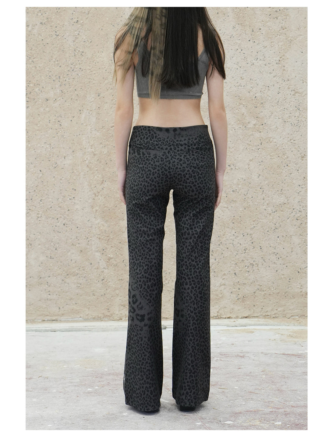 4RE1GN PANTHER crest-print corduroy flare pants in gray black — back modeled view showing the leopard print and flared hems