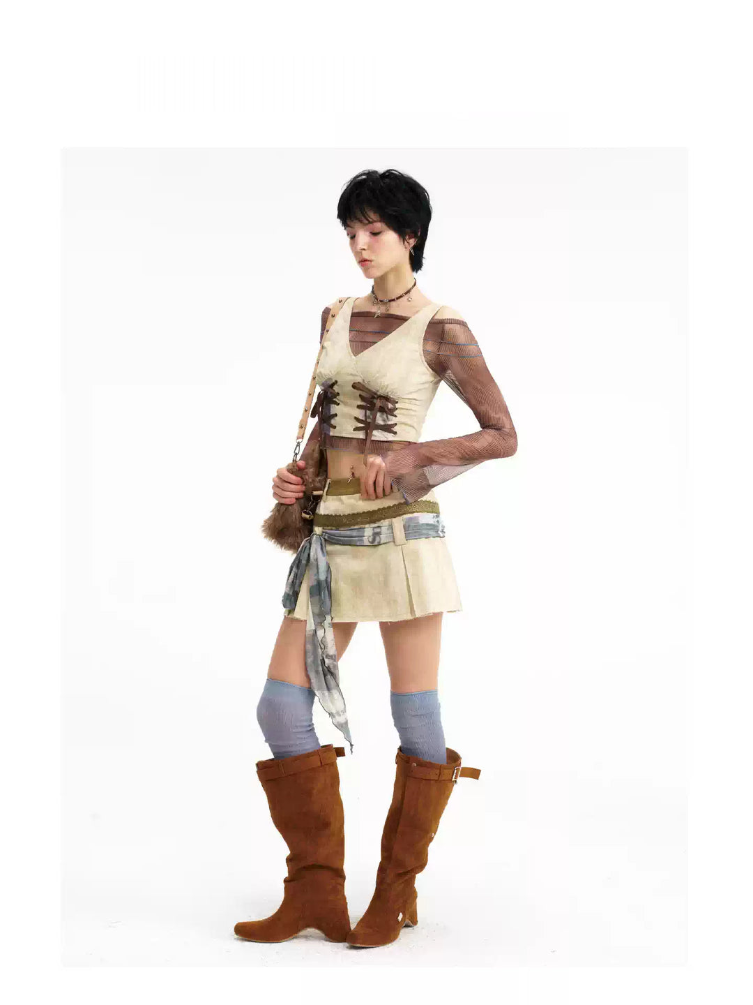Side-front view showing the cropped vest and layered skirt waistband