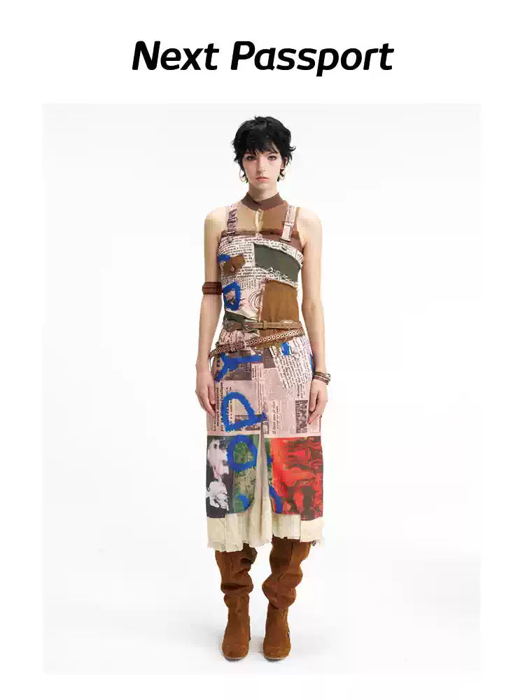 NEXT PASSPORT newspaper-print slit suspender dress — straight-on front full-length view.