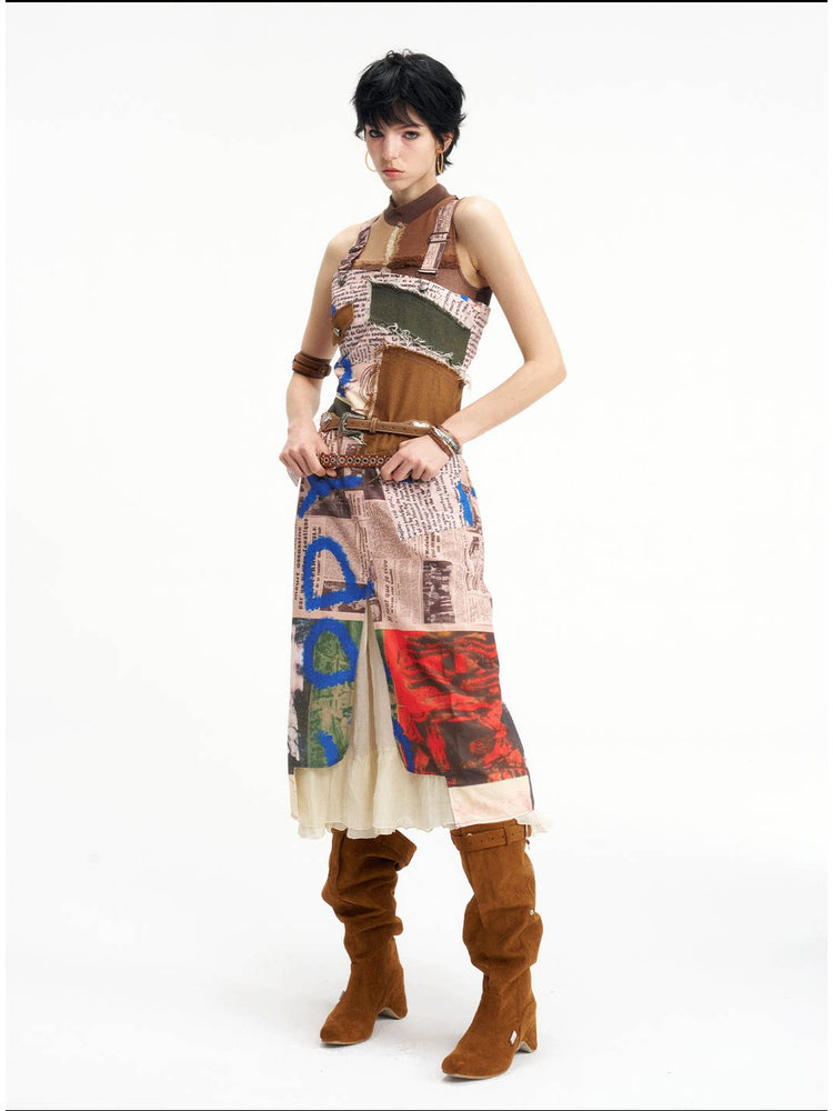 NEXT PASSPORT newspaper-print slit suspender dress — alternate front three-quarter view.