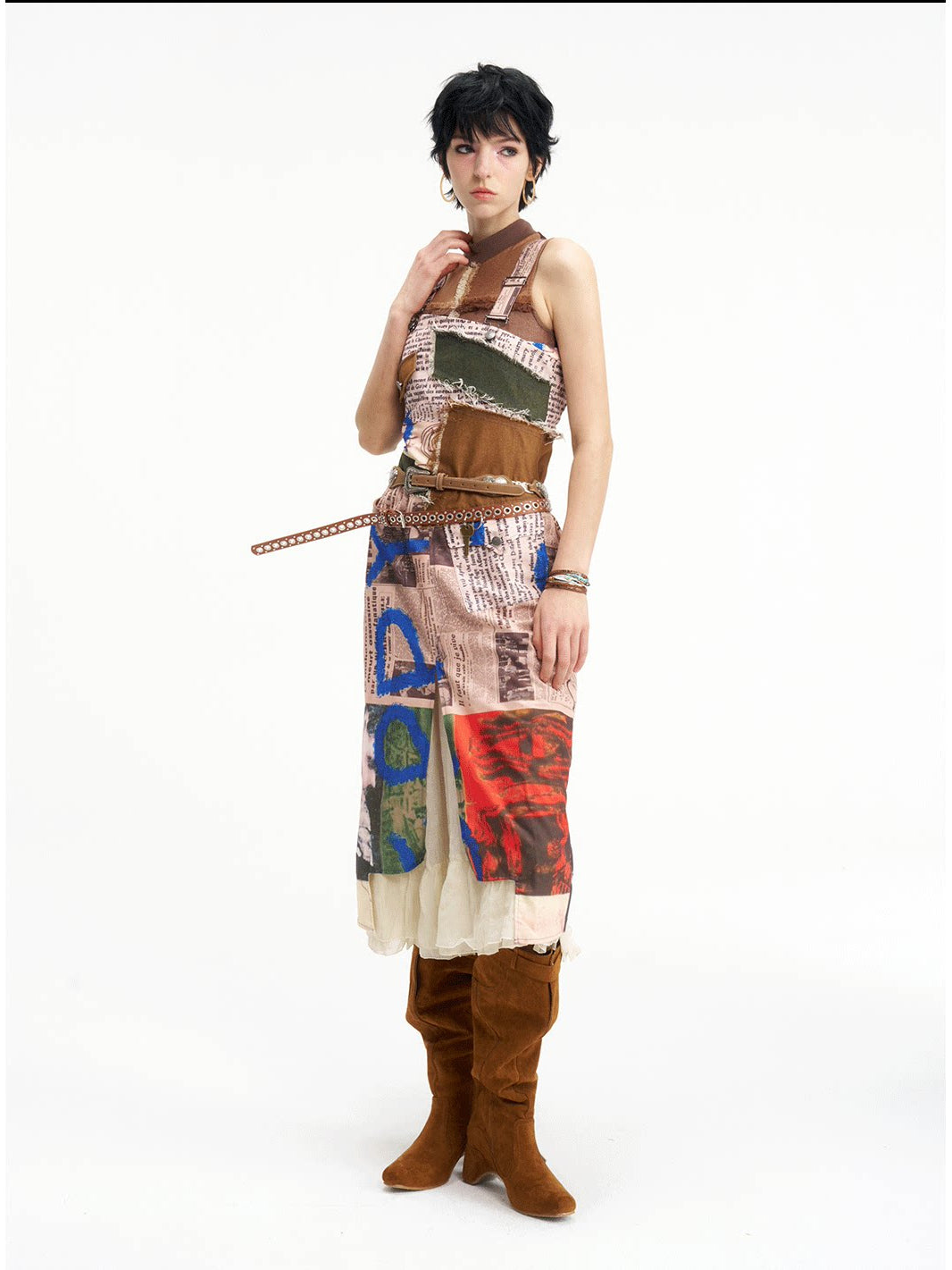 NEXT PASSPORT newspaper-print slit suspender dress — front view with extended waist strap.
