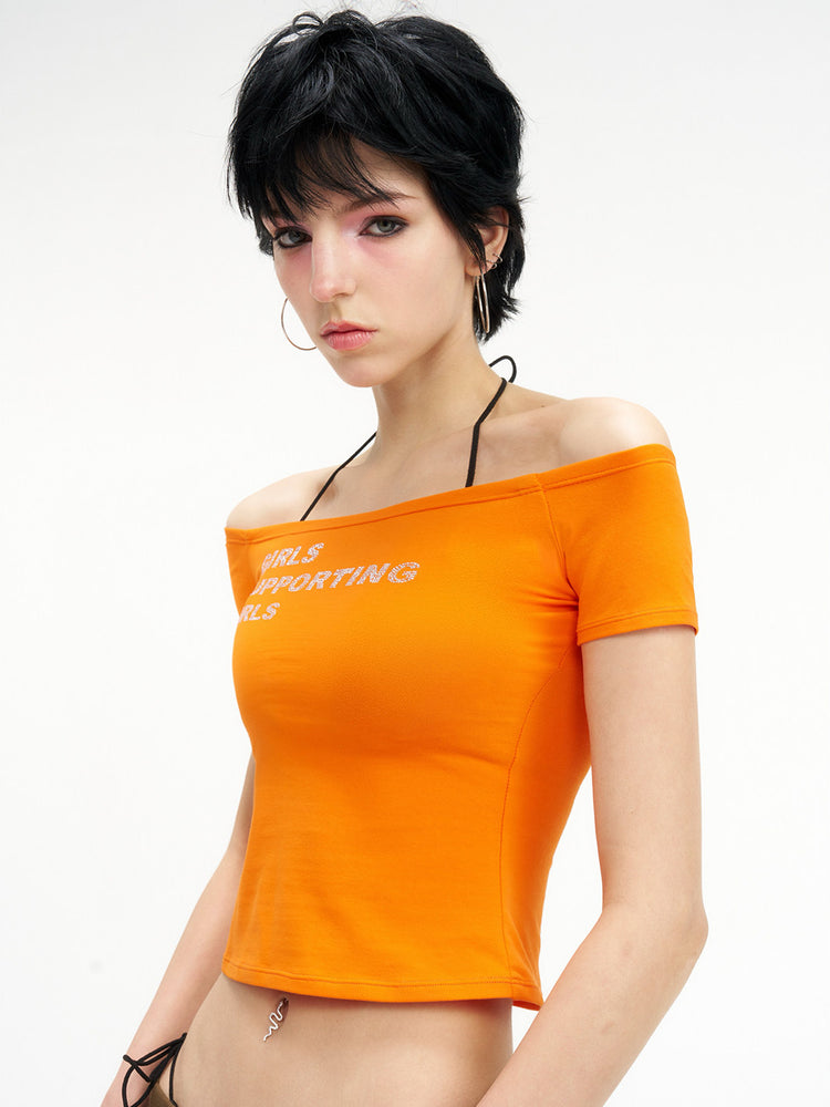 NEXT PASSPORT GIRLS SUPPORTING GIRLS rhinestone off-shoulder crop tee — orange waist-up modeled front view.