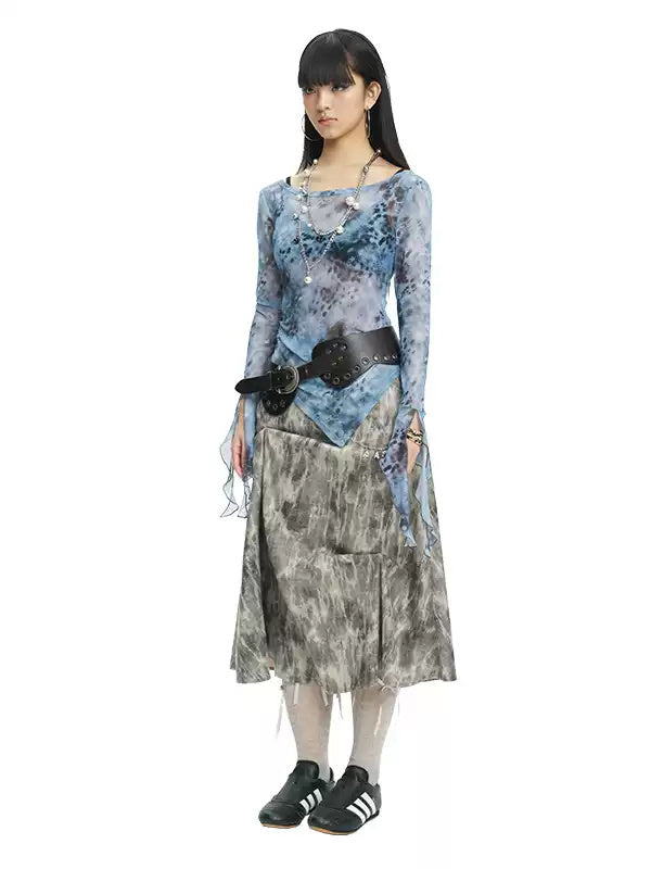 NEXT PASSPORT gray crinkled-print midi skirt modeled with a blue printed top and black belt.