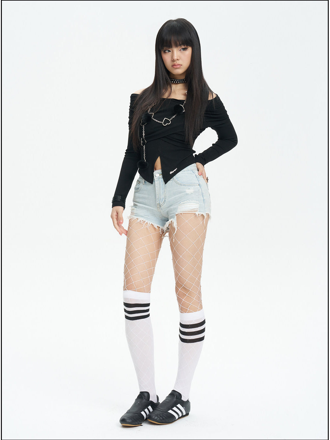 NEXT PASSPORT distressed fringe denim shorts in denim blue — full-length modeled view with white leg warmers.