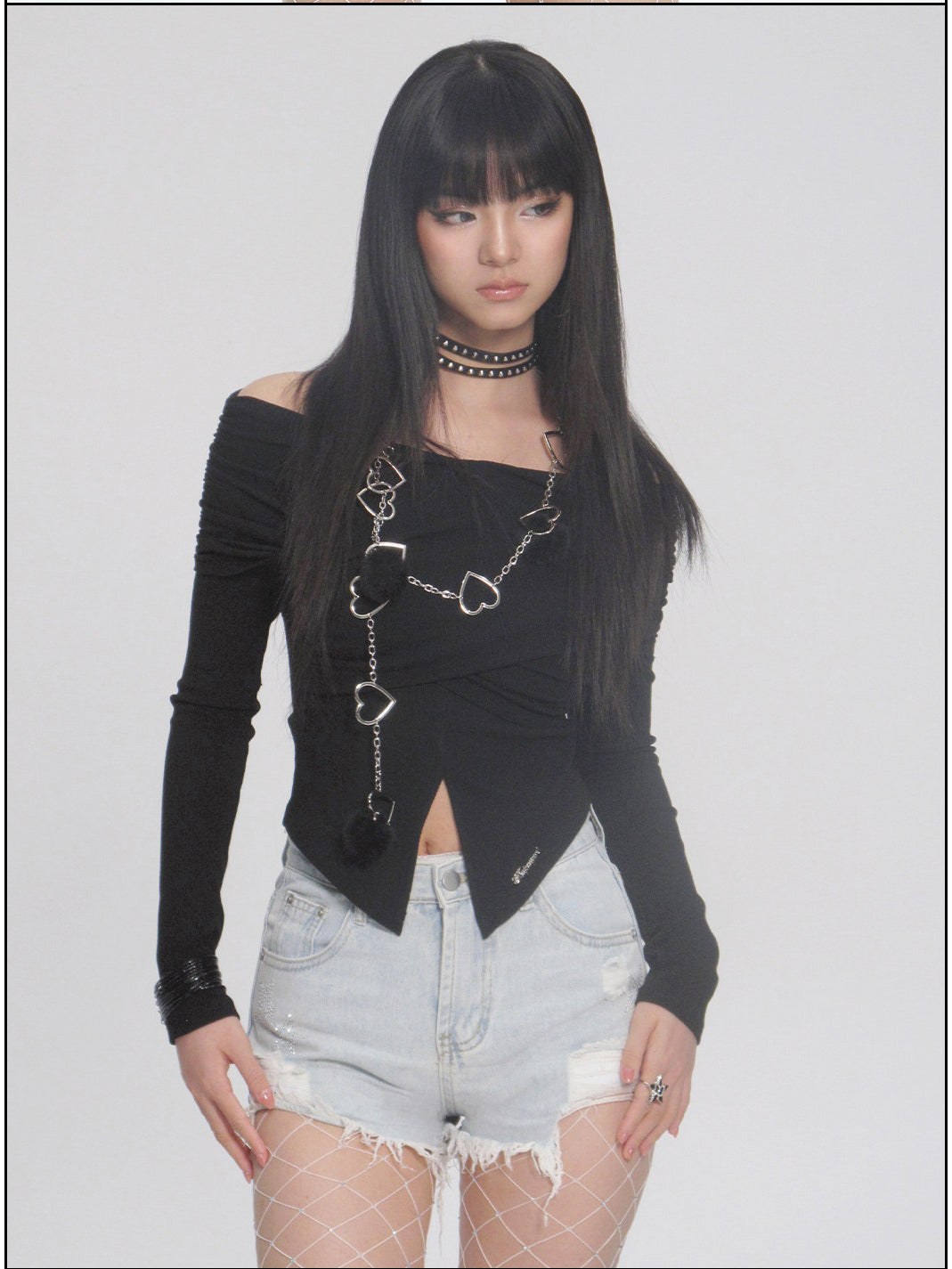 NEXT PASSPORT distressed fringe denim shorts in denim blue — close front modeled view emphasizing the fringe hem.