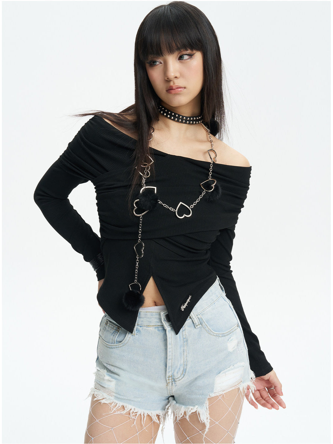 NEXT PASSPORT distressed fringe denim shorts in denim blue — three-quarter modeled view showing the irregular fringe and distressing.