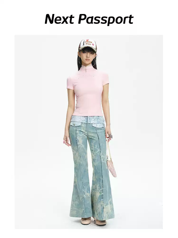 NEXT PASSPORT printed lace-panel flared jeans in pale blue — full-length front modeled view with pink top.