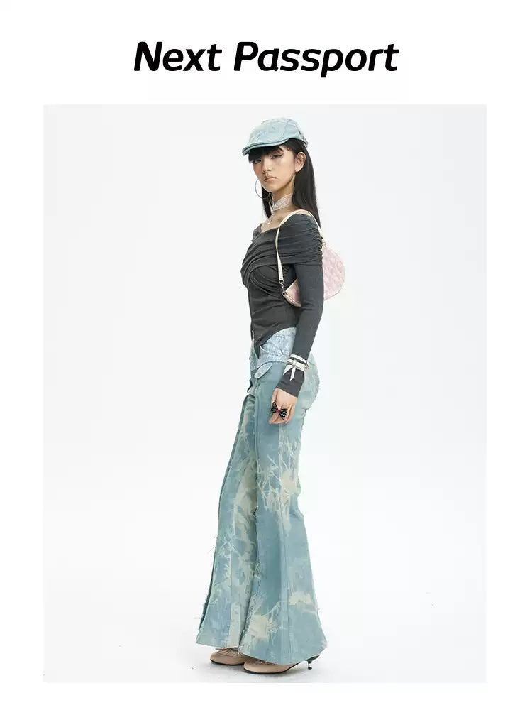 NEXT PASSPORT printed lace-panel flared jeans in pale blue — full-length side modeled view with black top.