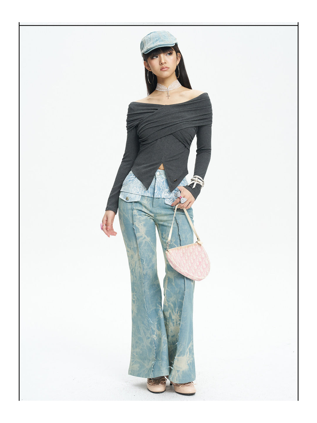 NEXT PASSPORT printed lace-panel flared jeans in pale blue — full-length front modeled view with black top and pink bag.