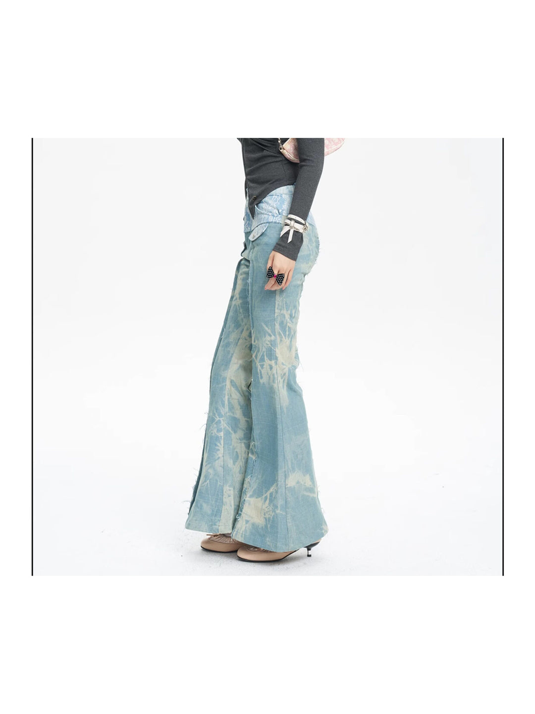 NEXT PASSPORT printed lace-panel flared jeans in pale blue — full-length side modeled view emphasizing the flare.