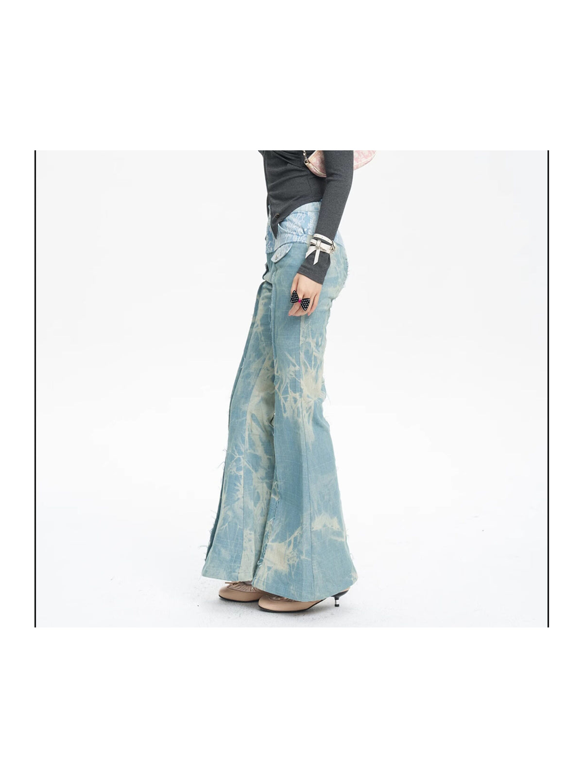 NEXT PASSPORT printed lace-panel flared jeans in pale blue — full-length side modeled view emphasizing the flare.