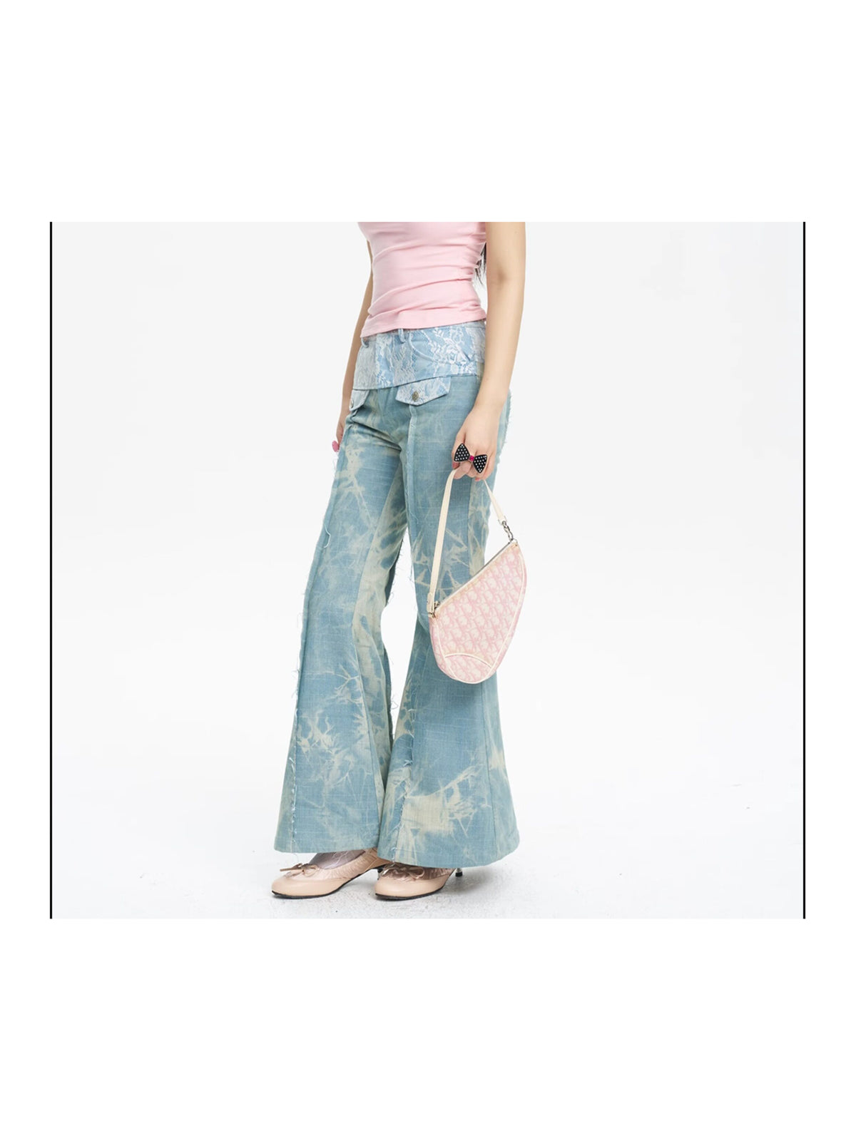 NEXT PASSPORT printed lace-panel flared jeans in pale blue — three-quarter modeled view with pink top.