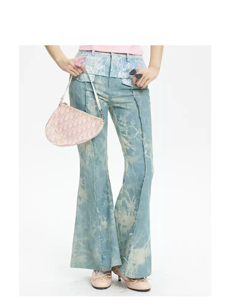 NEXT PASSPORT printed lace-panel flared jeans in pale blue — close front modeled view with pink top.
