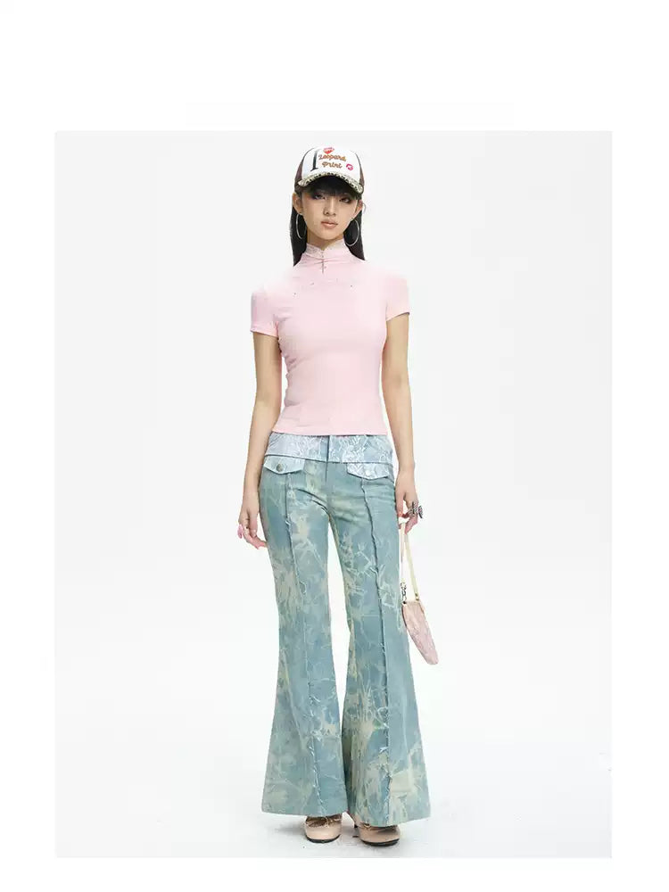 NEXT PASSPORT printed lace-panel flared jeans in pale blue — full-length front modeled view with pink top.
