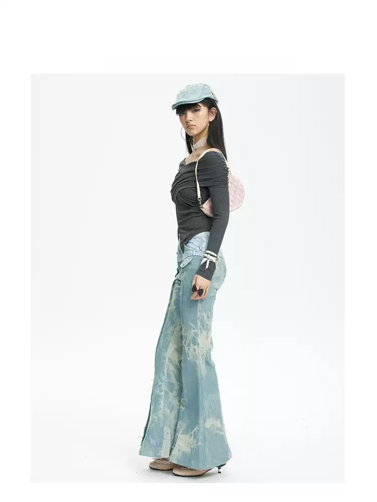 NEXT PASSPORT printed lace-panel flared jeans in pale blue — full-length side modeled view with black top.