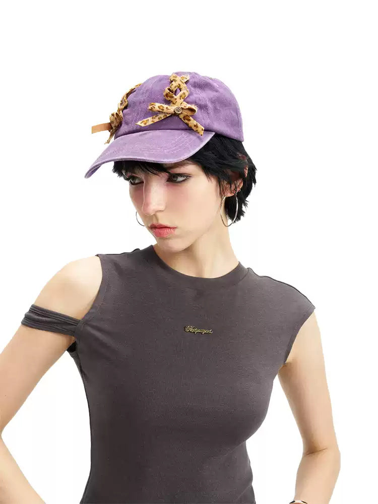 NEXT PASSPORT purple leopard lace-up baseball cap worn front three-quarter view