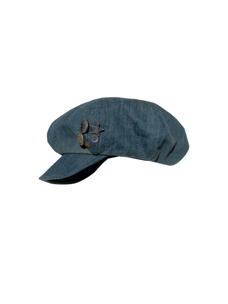 NEXT PASSPORT blue denim button-trim newsboy cap — solo front product view on white