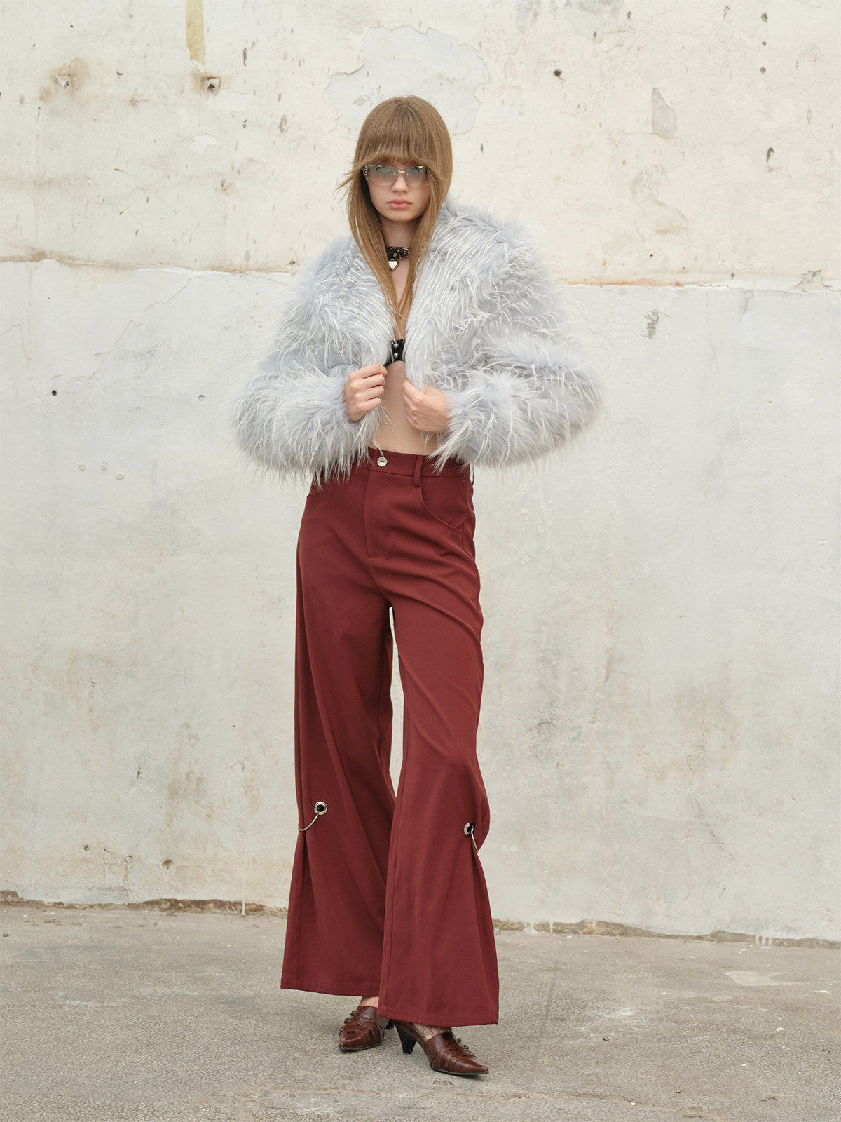 NEXT PASSPORT icy-blue long-pile faux-fur cropped jacket — open-front styling with burgundy trousers.