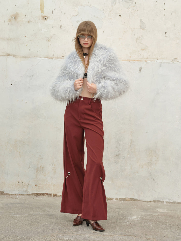 NEXT PASSPORT icy-blue long-pile faux-fur cropped jacket — open-front styling with burgundy trousers.