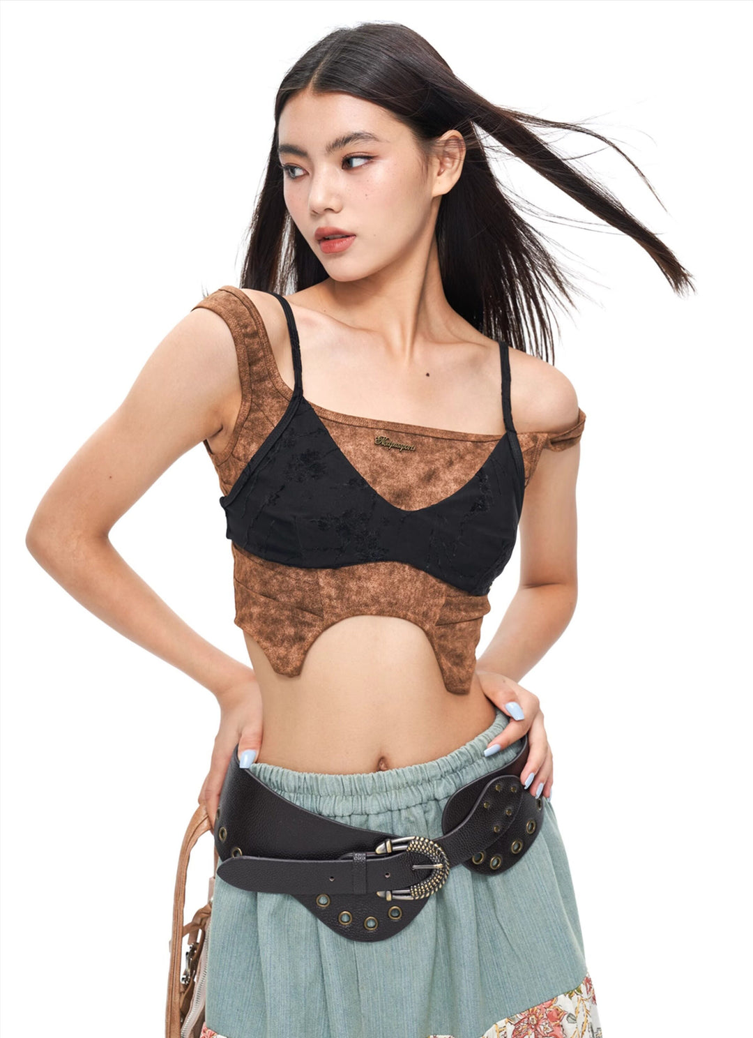 NEXT PASSPORT wasteland-brown shark-pleat vest and mini skirt — editorial full-length view
