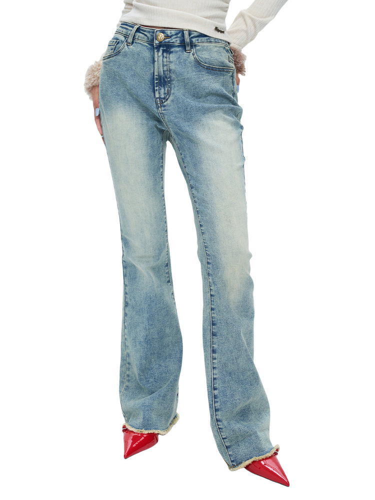 NEXT PASSPORT vintage light-wash stretch flared jeans in blue — front close-up showing the faded wash and long flare.
