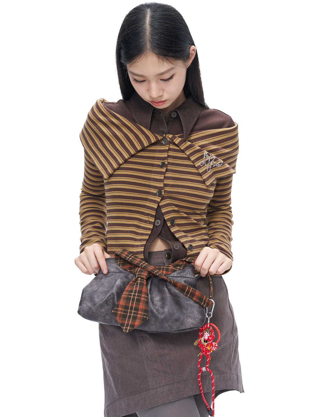 Side studio view showing the draped wide collar and striped knit of the NEXT PASSPORT cardigan
